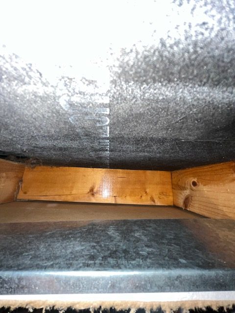 Air duct cleaning technician using professional Rotobrush equipment